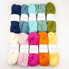 Load image into Gallery viewer, A collection of skeins of BC Garn Soft Silk yarn in various colors including blue, green, pink, orange, yellow, and cream.