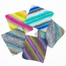 Load image into Gallery viewer, A circle of colorful striped crochet potholders