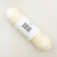 Load image into Gallery viewer, Cream skein of yarn with a label on a white background
