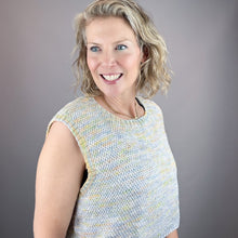 Load image into Gallery viewer, Woman wearing a multicolor sleeveless knitted top against a gray background
