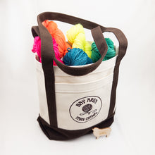 Load image into Gallery viewer, Canvas Tote with Bay Area Yarn Crawl logo full of colorful yarn
