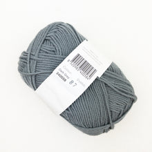 Load image into Gallery viewer, A skein of dark grey Debbie Bliss Baby Cashmerino yarn on a white background.
