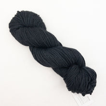 Load image into Gallery viewer, A black skein of Blue Sky Fibers Hand Dyes yarn on a white background
