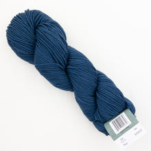 Load image into Gallery viewer, A skein of navy blue Plymouth DK Merino Superwash yarn on a white background.
