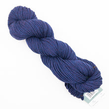 Load image into Gallery viewer, A skein of heathered navy Plymouth DK Merino Superwash yarn on a white background.
