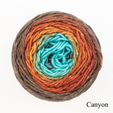 Load image into Gallery viewer, A blue and orange ball of Freia Merino Silk Worsted ombre yarn 
