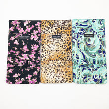 Load image into Gallery viewer, Three Atelier Yarns Interchangeable Knitting Needle Cases in Cherry Blossom, Cheetah, and Green Wave prints on a white background
