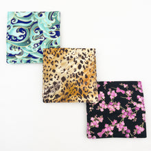 Load image into Gallery viewer, Three closed Atelier Yarns Interchangeable Knitting Needle Cases in Cherry Blossom, Cheetah, and Green Wave prints on a white background
