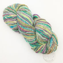 Load image into Gallery viewer, A green, maroon, and brown skein of variegated Noro Kochoran yarn on a white background.
