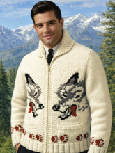 Load image into Gallery viewer, Man wearing a cream-colored sweater with wolf designs in a mountainous landscape
