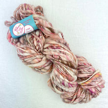 Load image into Gallery viewer, A pink, cream, and brown skein of Knit Collage Cast Away yarn.
