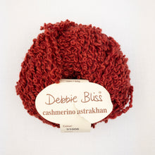 Load image into Gallery viewer, A red ball of Debbie Bliss Astrakhan yarn on a white background
